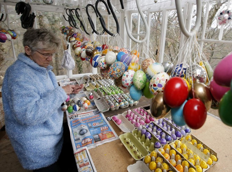 Image: German pensioner Kraft compiles Easter eggs before decorating an apple tree with them in Saalfeld