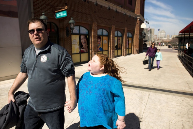 Image: Alexis Shapiro, 12, walks with her father Ian Shapiro