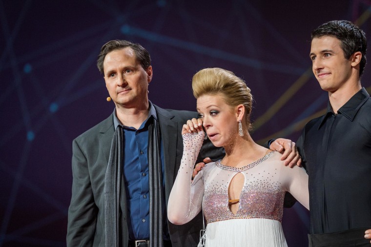 Image: Boston Marathon bombing survivor Adrianne Haslet-Davis, center, wipes a tear as she stands with Hugh Herr, director of the Biomechatronics group at The MIT Media Lab, left, and dancer Christian Lightner, right, during the international TED 2014 con