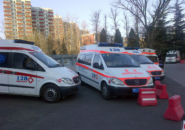 Ambulances in front of the Lido Hotel in Beijing, the main gathering point for Chinese relatives of the missing Malaysia Airlines passengers.