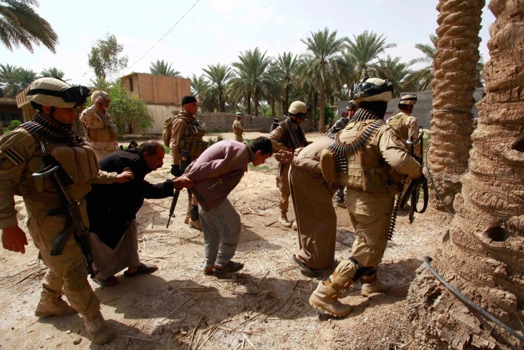 Image: Personnel from Iraqi security forces arrest suspected militants of the al Qaeda-linked Islamic State in Iraq and the Levant (ISIL), during clashes with Iraqi security forces in Jurf al-Sakhar