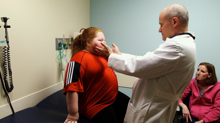 Image: Dr. Thomas Inge, a pediatric obesity expert at Cincinnati Children’s Hospital Medical Center, examines Alexis Shapiro, 12, before she receives life-changing weight-loss surgery
