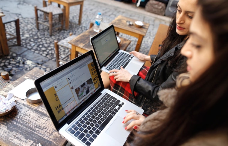 Image: Two Turkish women try to connect to Twitter on their laptops at a cafe in Istanbul on Friday.