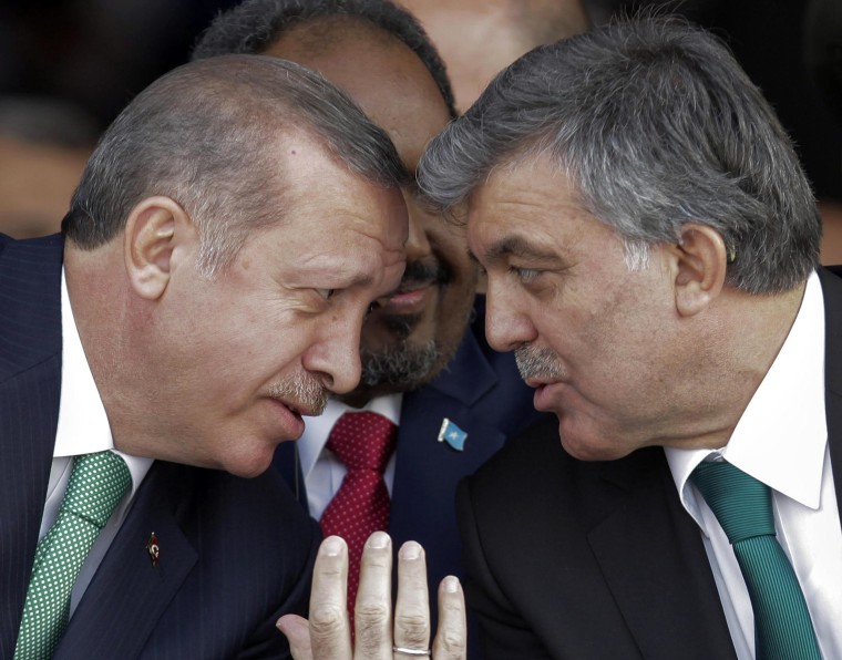 Turkey's President Gul and PM Erdogan chat as President of Somalia Sheikh Mohamud sits between them during opening ceremony of Marmaray  in Istanbul