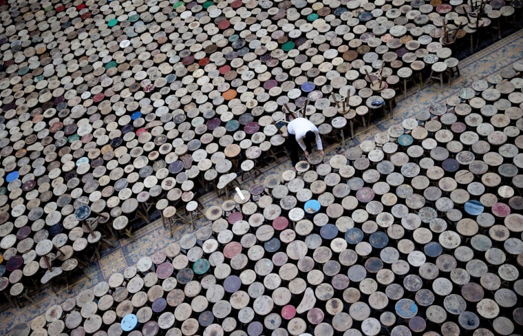 A staff member helps to set up the installation "Stools" of Chinese artist Ai Weiwei made of 6,000 stools in the atrium of the Martin-Gropius-Bau exhibition hall in Berlin, Germany on March 21. The worldwide largest one-man exhibition of the Chinese dissident and artist was dubbed "Evidence" and will be shown from April 3 to July 7. The show includes works that were specifically created for the Marin-Gropius-Bau exhibition.