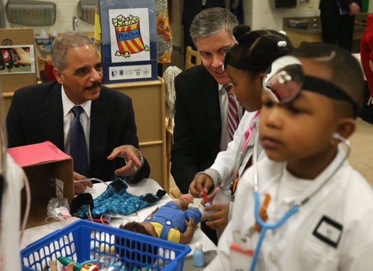 Image: Eric Holder And Arne Duncan Visit Washington DC Elementary School