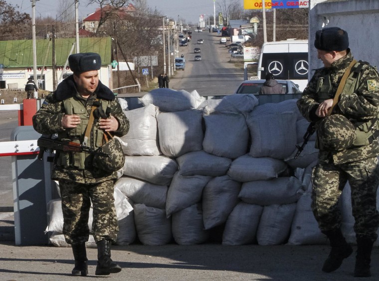 Image: Ukrainian border guards stand at a checkpoint with Moldova's breakaway Trans-Dniester region