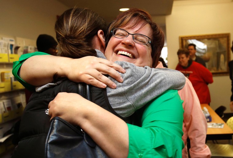 Image: Plaintiff Deboer celebrates with a supporter at the Affirmations Center after a Michigan federal judge ruled that a ban on same-sex marriage violates the U.S. Constitution and must be overturned, in Ferndale