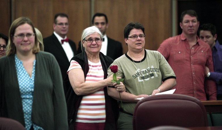 Same-sex couples are married in a group ceremony at the Oakland County Courthouse on Saturday in Pontiac, Mich.