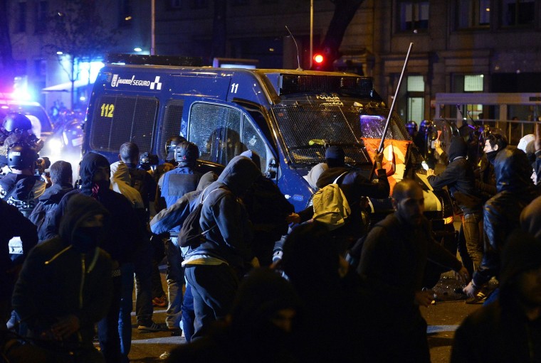 Image: Demonstrators attack a police van during clashes at the end of a march to protest against austerity in Madrid