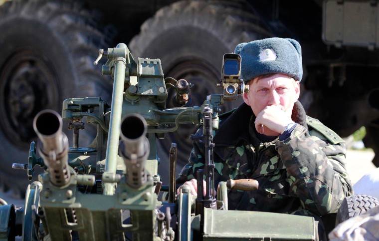 Image: A Ukrainian serviceman guards a military base in the Crimean town of Belbek near Sevastopol