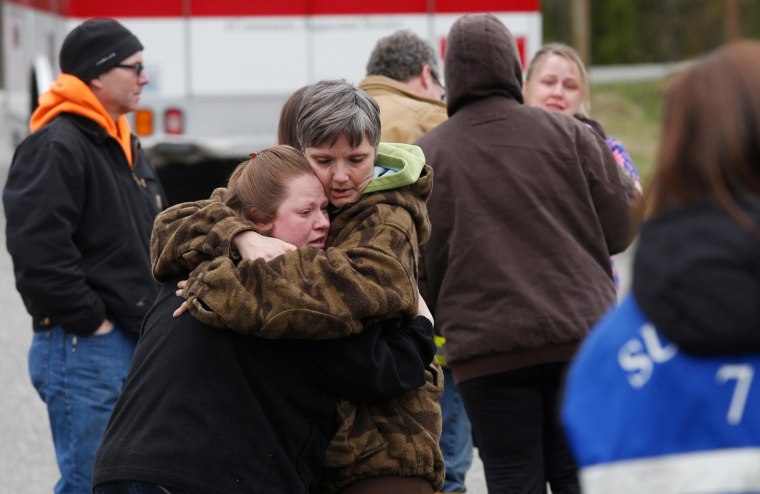 Image: Neighbors gather at the Oso Fire Department to wait for updates about the fatal mudslide that washed over homes and over Highway 530 east of Oso, Wash.