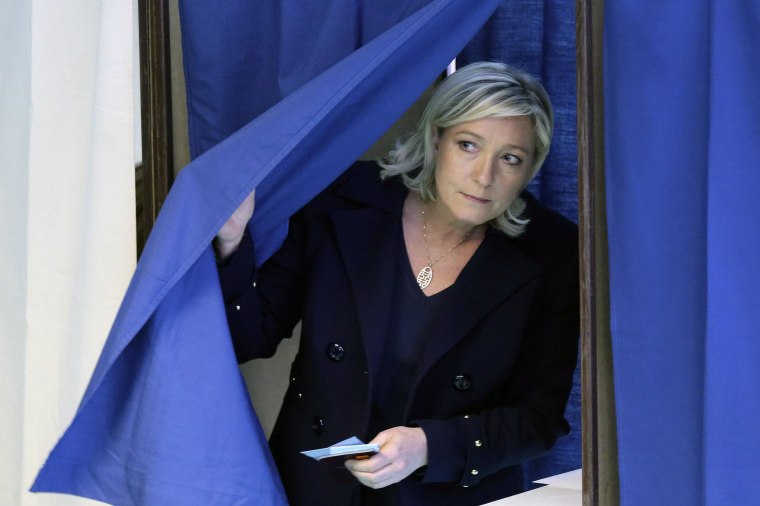 Image: France's far-right National Front political party leader Marine Le Pen leaves a polling booth as she votes during the first round in the French mayoral elections in Henin Beaumont