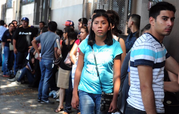 Young people wait in line to enter the offices of the Coalition for Humane Immigrant Rights of Los Angeles (CHIRLA) on August 15, 2012 in Los Angeles, California, on the first day of the Deferred Action for Childhood Arrivals (DACA) program.