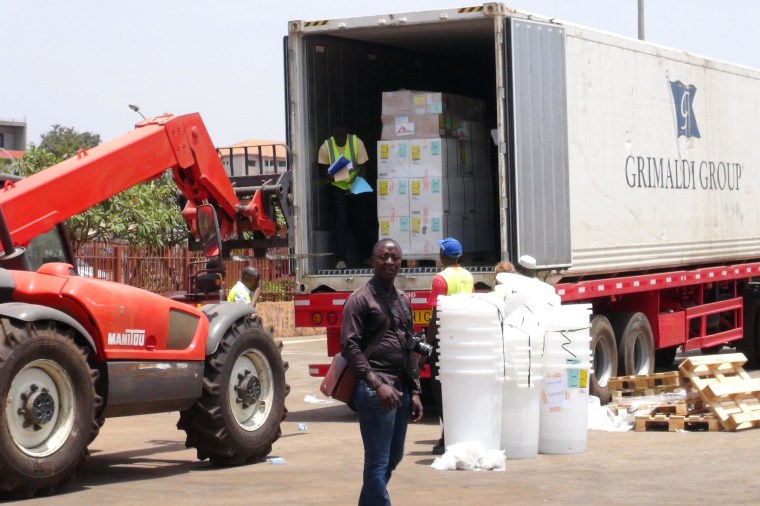 Image: Workers from Doctors Without Borders unload emergency medical supplies to deal with an Ebola outbreak in Conakry