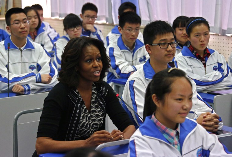 Image: U.S. first lady Michelle Obama sits in for an English class with students at Chengdu No. 7 High School in Chengdu