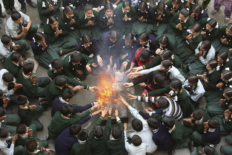 Image: Students attend a prayer ceremony in tribute to passengers and crew onboard missing Malaysia Airlines flight MH370, inside a school in Jammu