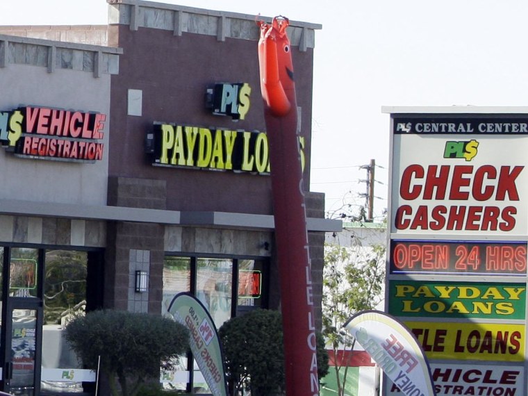 Image: Payday loan businesses advertise their services in Phoenix, Ariz.