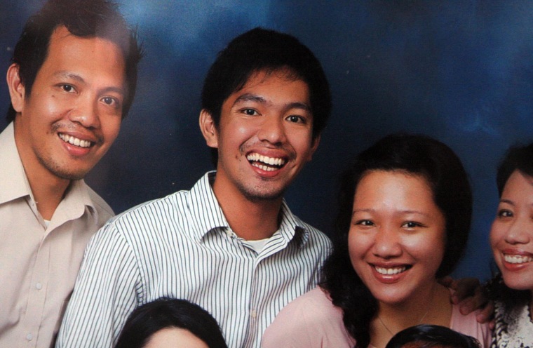 Image: Firman Chandra Siregar, center, posing with his brother and sisters in a family photo