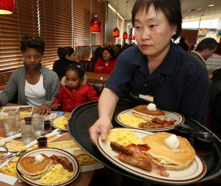 Denny's waiter serves breakfast