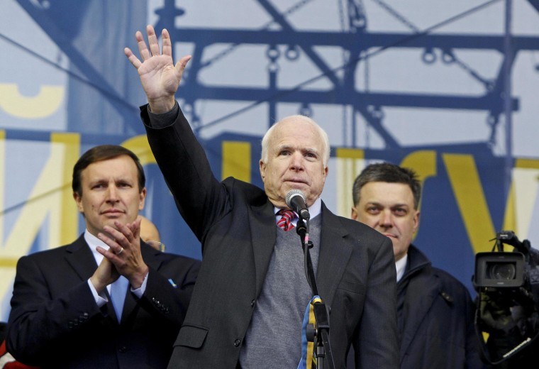 Image:  Sen. John McCain waves to pro-European protesters during a rally at Independence Square in Kiev in December