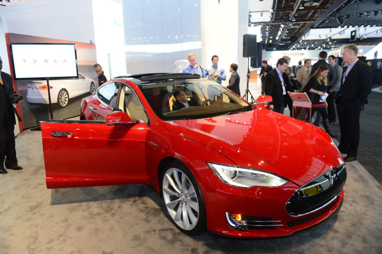 Road safety agency drops its probe of Tesla car fires as the electric automaker says it is adding a shield to protect the battery compartment.