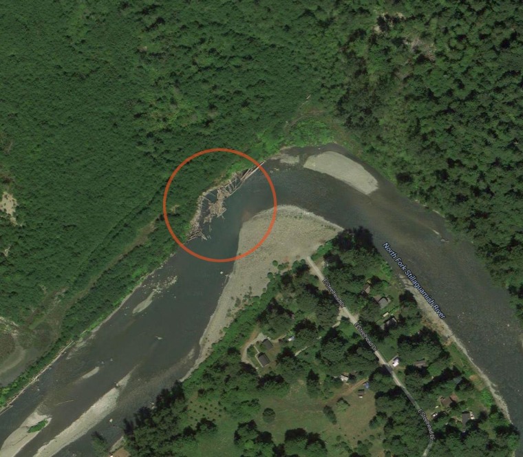 A Google Earth satellite image shows the bend in the Stillaguamish River in Oso, Wash., where a retaining wall appears to have broken apart.