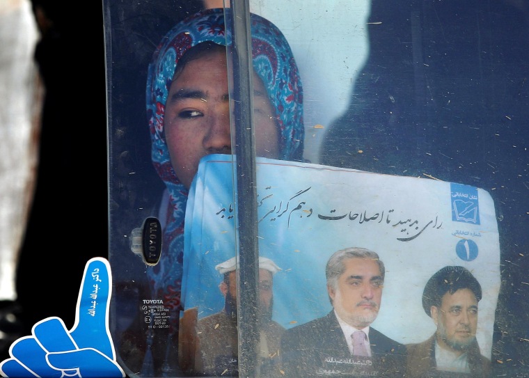 Image: A supporter of Afghan presidential candidate Abdullah looks out of a car window after an election rally in Mazar-I-Shariff