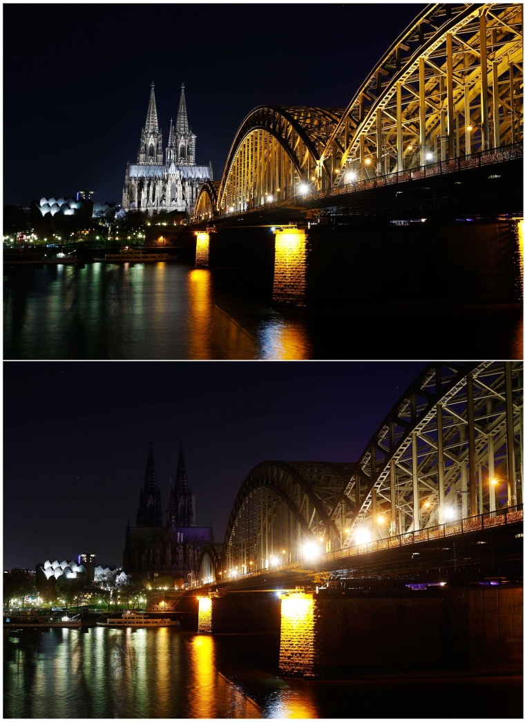 Image: The UNESCO World Heritage Cologne Cathedral and the Hohenzollern railway bridge along the river Rhine during and before Earth Hour