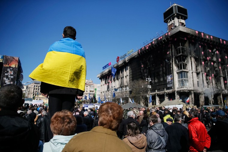 Image: People attend a religious service in Independence Square in Kiev