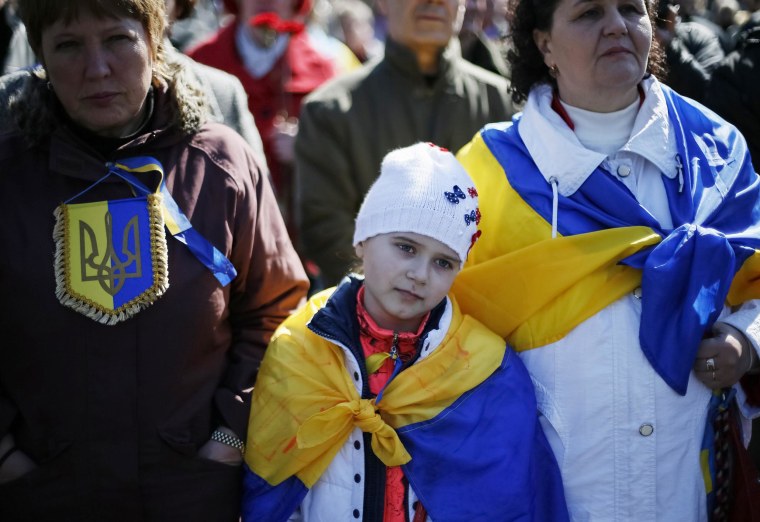 Image: People attend a religious service in Independence Square in Kiev