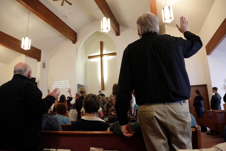 Image: People worship during service at the Glad Tidings Assembly of God church in Darrington