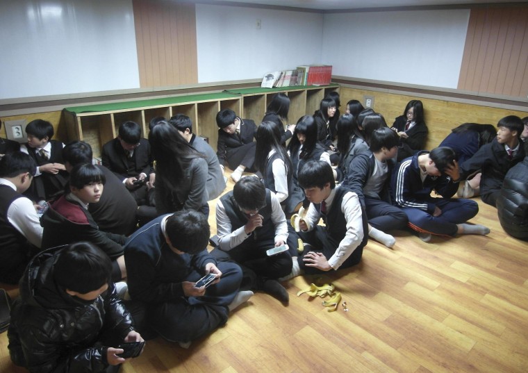 Image: South Korean students gather at a shelter on Yeonpyeong island, near the border with North Korea, on Monday.