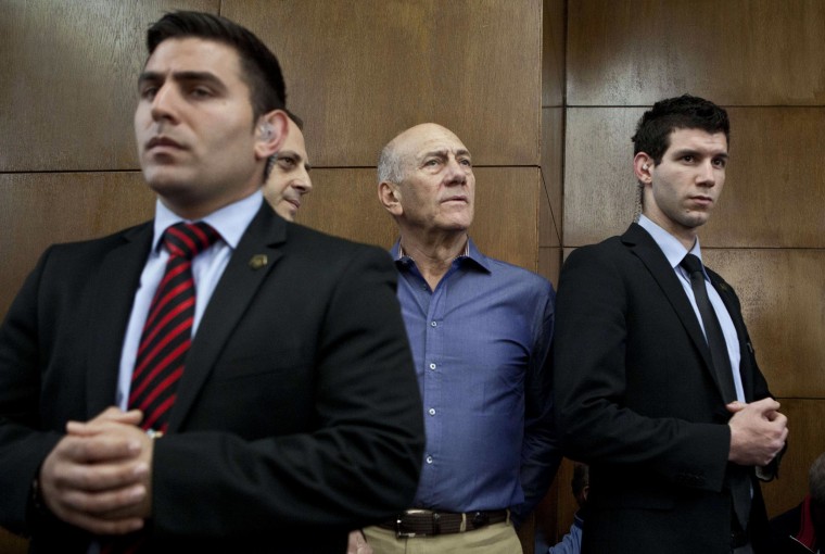 Image: Ehud Olmert, center, arrives in court on Monday