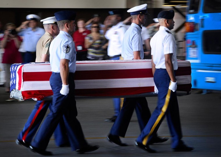 Image: A joint service honor guard escorts a transfer case during an "arrival ceremony" at Joint Base Pearl Harbor-Hickam in Honolulu on April 27, 2012. 