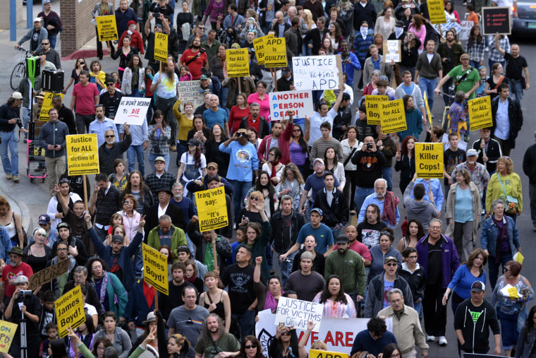 Image: Hundreds of people march north on Fifth Street to the headquarters of the Albuquerque Police Department
