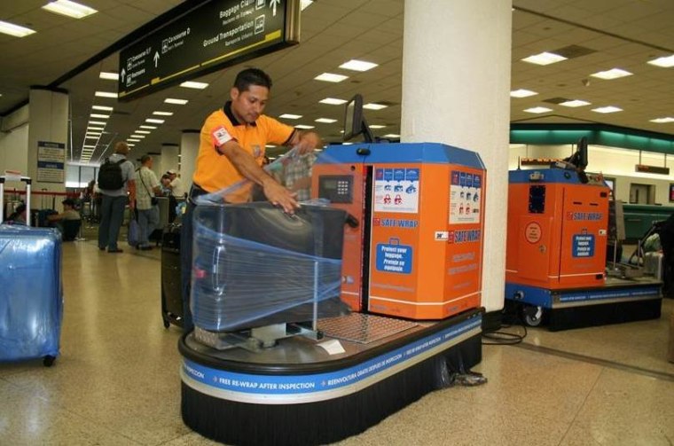 Image: suitcase wrapped in plastic