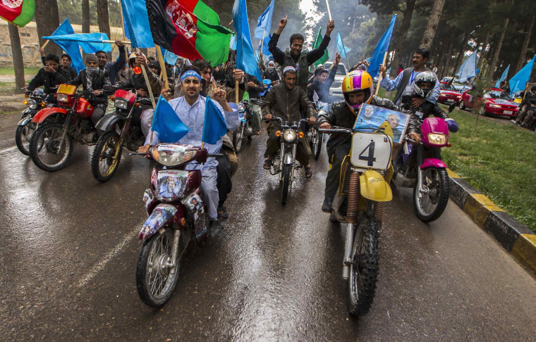 Image: Supporters of Afghan presidential candidate Abdullah Abdullah ride motorcycles, as they lead convoy after arrival to attend election campaign in Herat