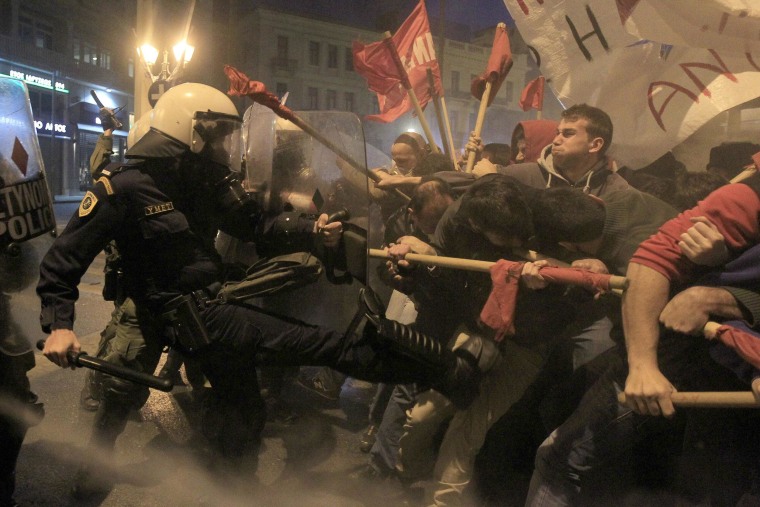 Image: Protesters clash with riot police during a protest in Athens