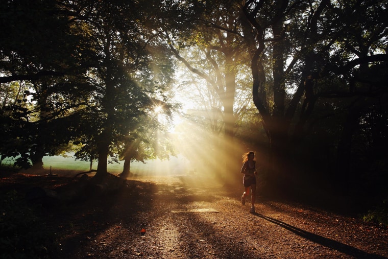 Image: A woman runs through the early morning light