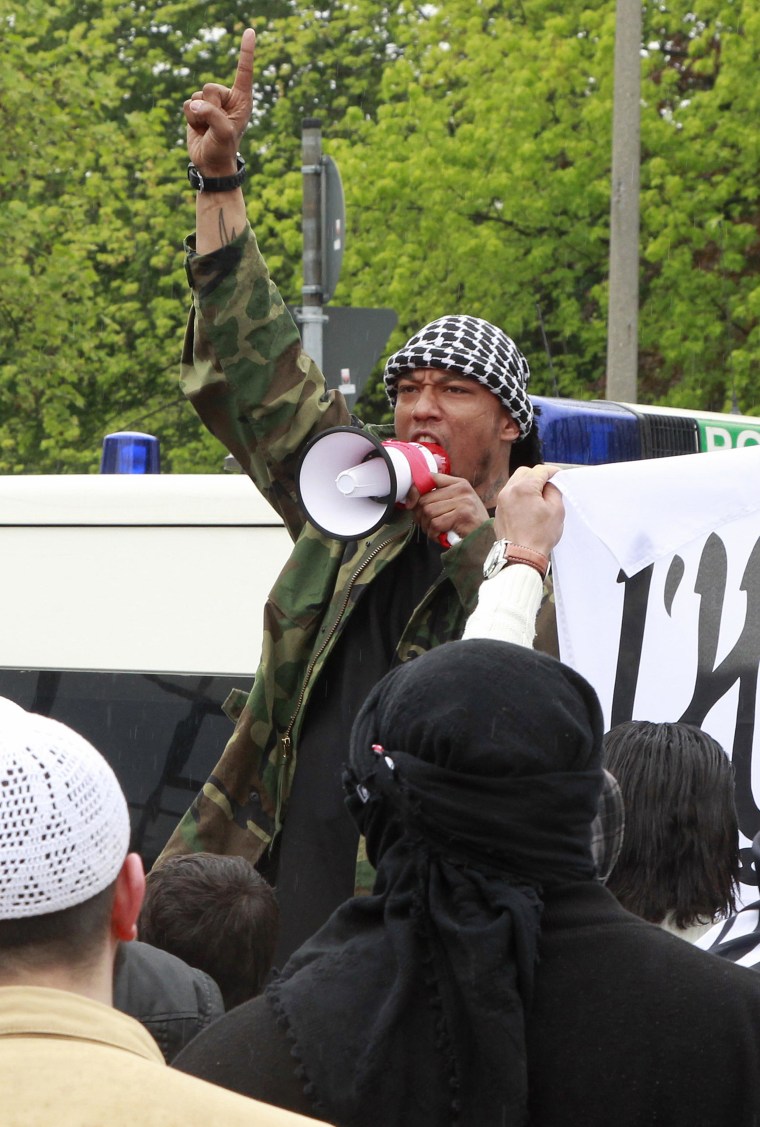 Rapper Deso Dogg, who converted to Islam in 2010, shouts into a megaphone during a rally in Bonn, Germany, in 2012.