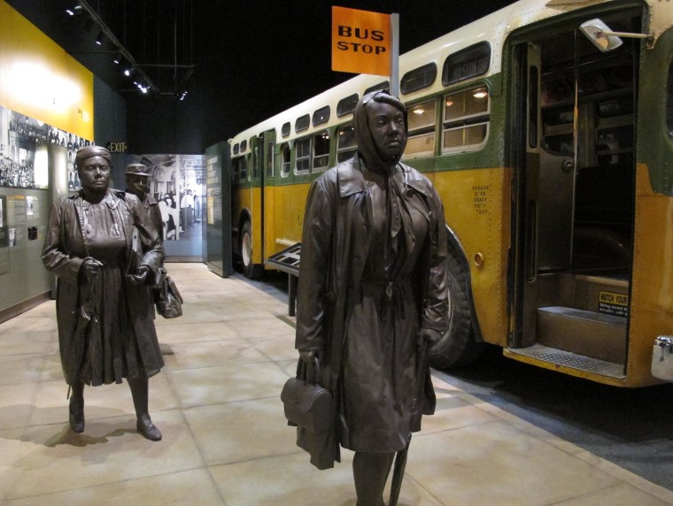 This March 19, 2014, photo shows statues of three women walking next to a replica of a city bus, part of an exhibit about Montgomery's bus boycotts at the newly renovated National Civil Rights Museum in Memphis, Tenn.