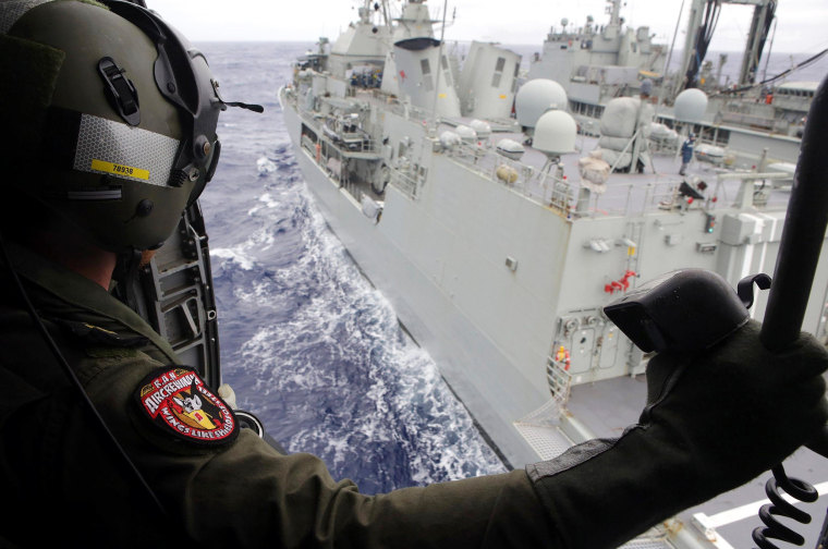 Image: Leading Seaman Aircrewman Joel Young looks out from Tiger75, an S-70B-2 Seahawk helicopter, after it launched from HMAS Toowoomba as it continues the search in the southern Indian Ocean for the missing Malaysian Airlines flight MH370