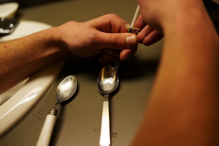 Image: A drug user addicted to heroin prepares drugs for injection in St. Johnsbury, Vt.