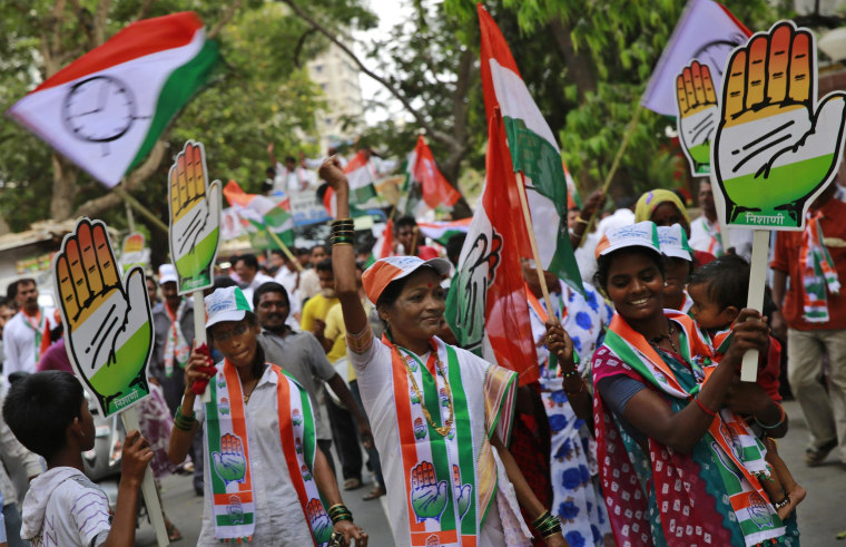 Image: Supporters of India's ruling Congress party dance at an election rally in Mumbai on Monday