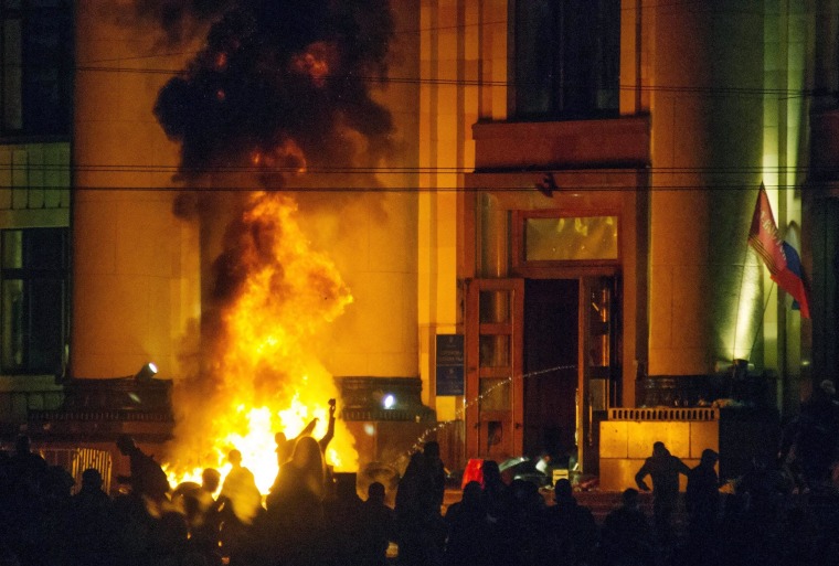 Image: Pro-Russian protesters burn tires near of a regional administration building after police cleared it in Kharkiv, Ukraine