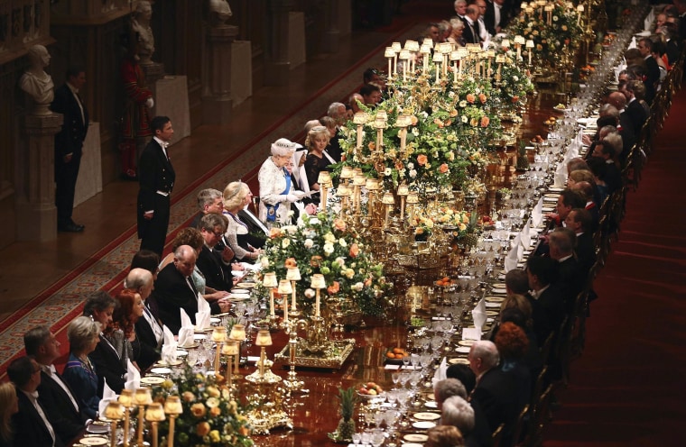 Image: Guests listen during a speech by Britain's Queen Elizabeth II in honour of Ireland's President Higgins during the Royal Banquet in Windsor