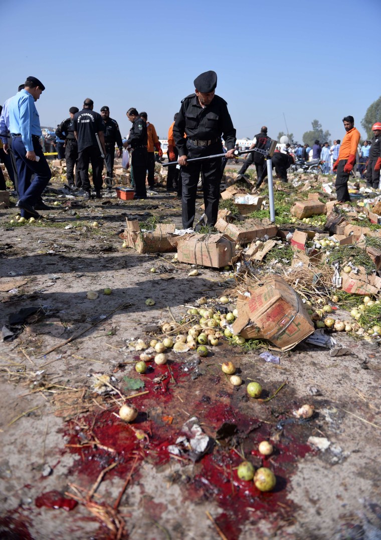 Image: Pakistani security officials inspect the site of a bomb explosion in Islamabad