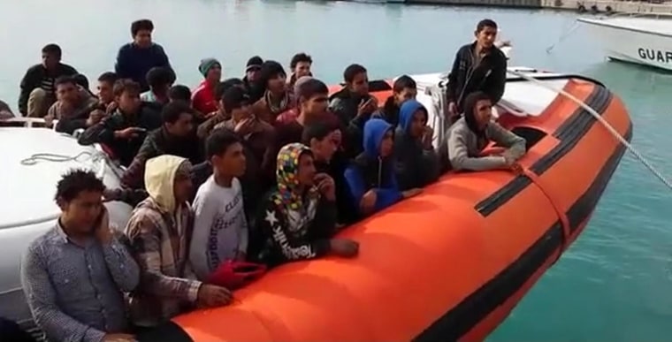 Image: Migrants rescued in the Strait of Sicily arrive in the port of Pozzallo, Sicily