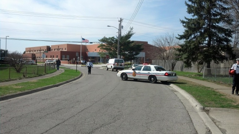Image: Police officers investigate the scene where two people, including a 14-year-old boy, have been shot on the grounds of an elementary school in Columbus, Ohio